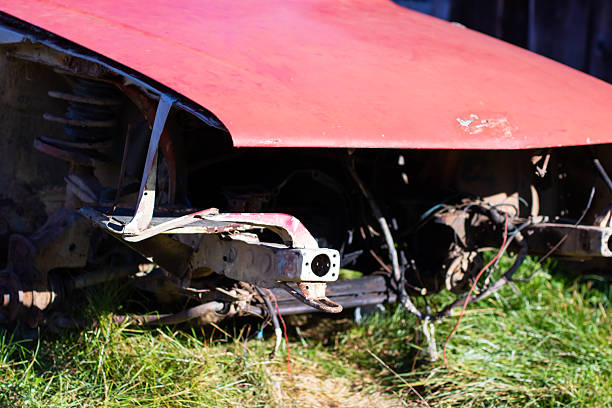 Vintage car abandoned and rusting away in rural countryside.