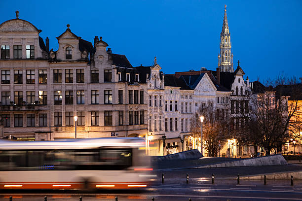 Brussels city skyline viewed from Mont des Arts just before sunrise. The tower of Brussels Town Hall can be seen on the horizon.