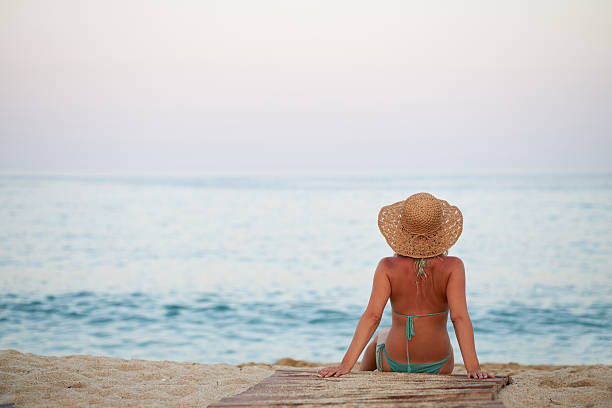 Beautiful woman sitting on the beach.