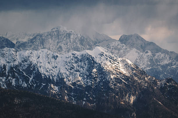 Cloudy winter mountain landscape. The Alps in a snowy/rainy day