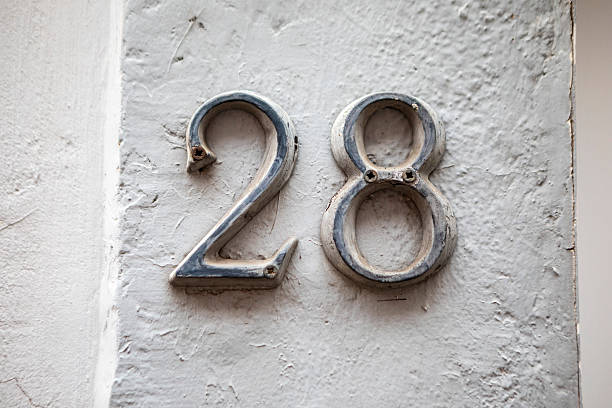 istock House number 28 on a rough textured wall 2257601977