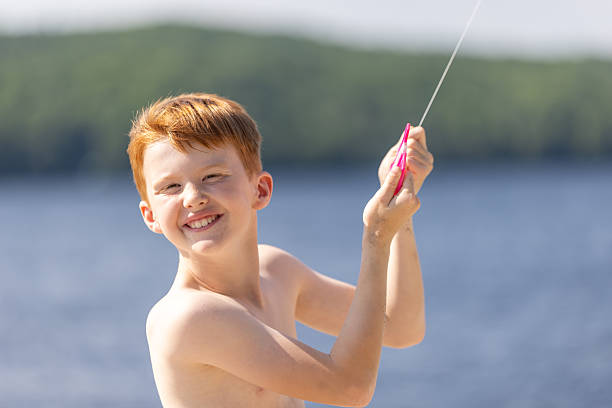 Young Redhead Boy Flying a Kite at the Beach During Summer, Quebec, Canada