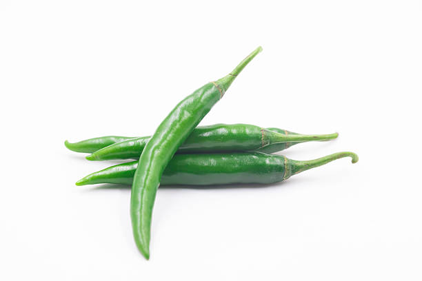 Green chili peppers isolated white background