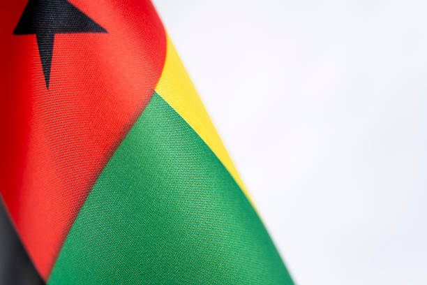 The image shows the national flag of Martinique, featuring three bold diagonal fields in green, red, and black. The fabric texture and vivid colors give the design a strong, modern visual presence, inspired by Pan-African symbolism.
