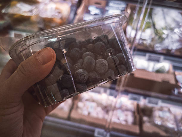 Buying Blueberries, POV. Person Hand Choosing Blueberries