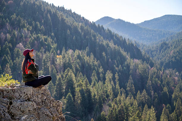 Woman practicing yoga and meditation in the mountain