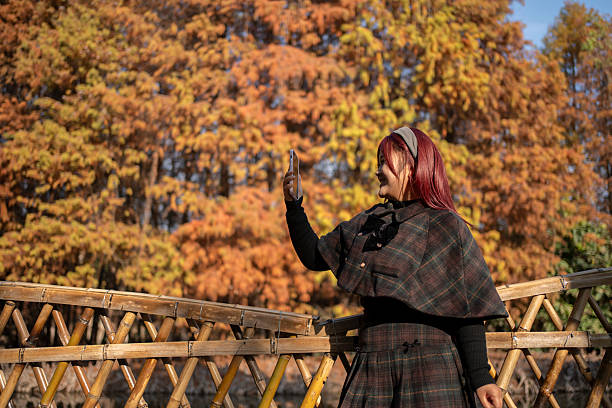 A beautiful woman using her phone in the forest