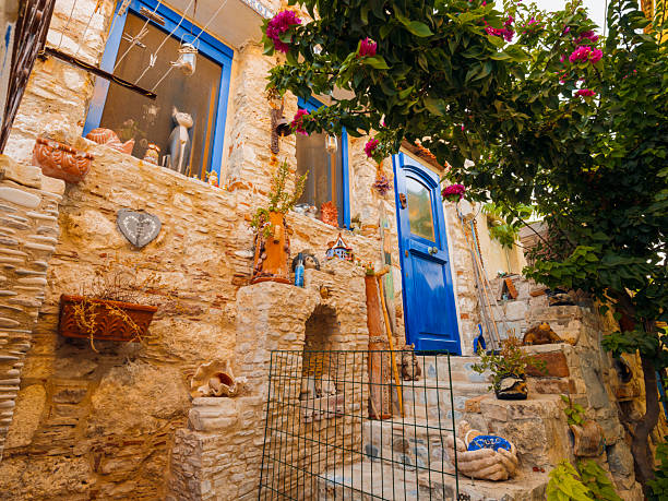 Colorful waterfront houses and traditional harbor views in Pythagoreio, a historic coastal town on Samos Island in the Aegean Sea, Greece. Clear summer skies, calm waters, and Mediterranean architecture reflect the island’s cultural heritage and relaxed seaside atmosphere.