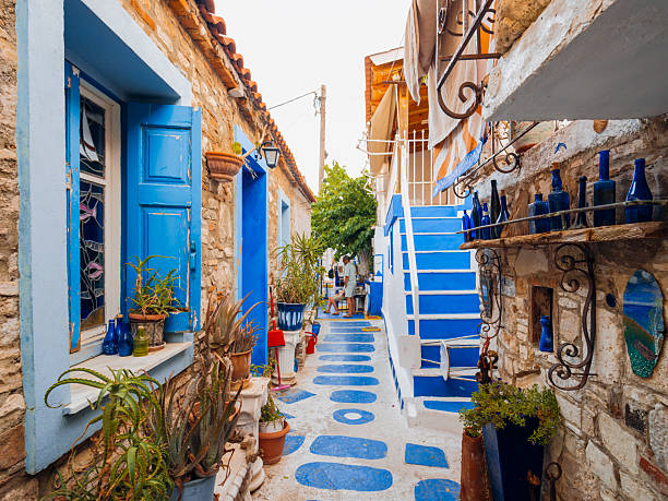 Colorful waterfront houses and traditional harbor views in Pythagoreio, a historic coastal town on Samos Island in the Aegean Sea, Greece. Clear summer skies, calm waters, and Mediterranean architecture reflect the island’s cultural heritage and relaxed seaside atmosphere.