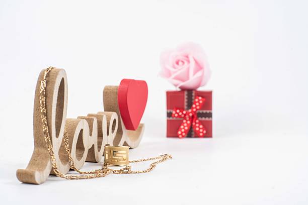 heart and valentine's gift box and a rose and word love with white background