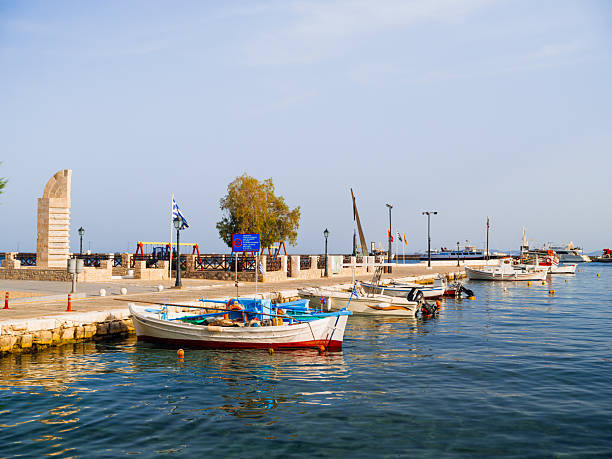 Colorful waterfront houses and traditional harbor views in Pythagoreio, a historic coastal town on Samos Island in the Aegean Sea, Greece. Clear summer skies, calm waters, and Mediterranean architecture reflect the island’s cultural heritage and relaxed seaside atmosphere.