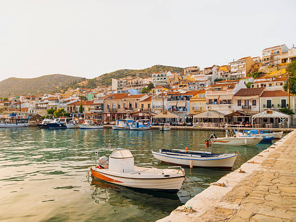 Colorful waterfront houses and traditional harbor views in Pythagoreio, a historic coastal town on Samos Island in the Aegean Sea, Greece. Clear summer skies, calm waters, and Mediterranean architecture reflect the island’s cultural heritage and relaxed seaside atmosphere.