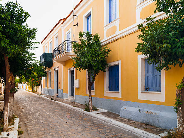 Colorful waterfront houses and traditional harbor views in Pythagoreio, a historic coastal town on Samos Island in the Aegean Sea, Greece. Clear summer skies, calm waters, and Mediterranean architecture reflect the island’s cultural heritage and relaxed seaside atmosphere.