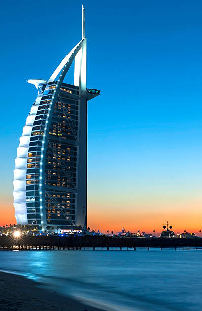 Dubai, UK - March 16, 2025: A vertical view of the iconic Burj Al Arab luxury hotel in Jumeirah, Dubai, UAE.