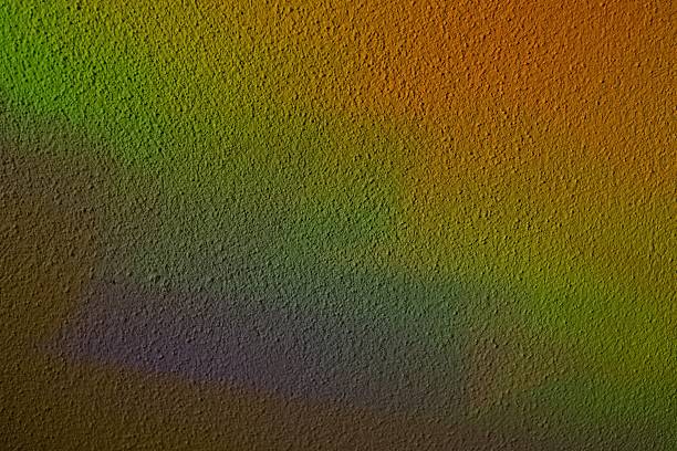 Soft colorful light from stained glass projected onto a textured wall. Abstract rainbow reflections create an artistic background with gentle gradients and natural illumination. Ideal for creative design, spirituality, architecture and mood concepts.