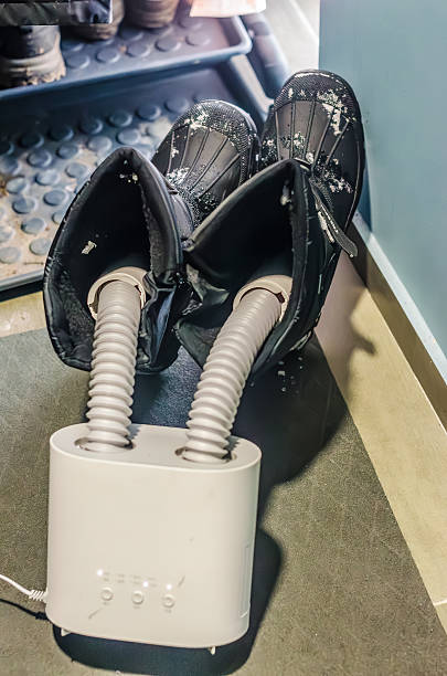 A practical home appliance for drying footwear. This electric dryer with flexible tubes warms and dries wet, snowy boots after winter activities.. High quality photo