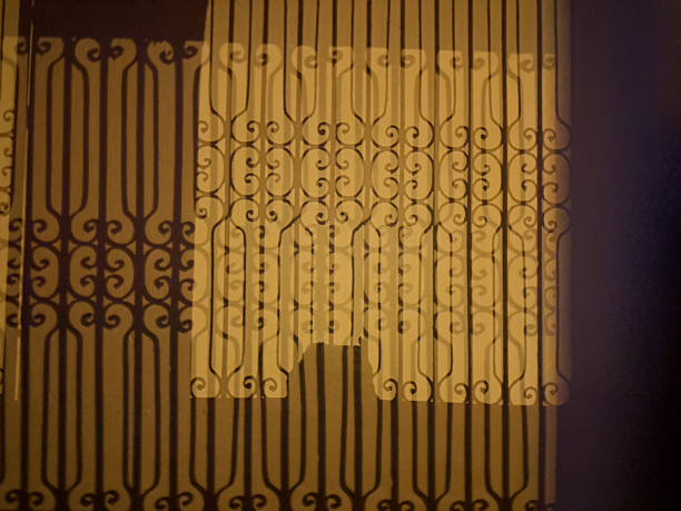 Dramatic Night Shadows and Yellow Light on Building Facade