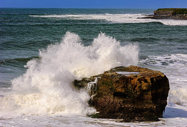 Wide view of waves crashing on shore rocks of Garrapata Beach.Taken at Garrapata Beach, Big Sur, California, USA
