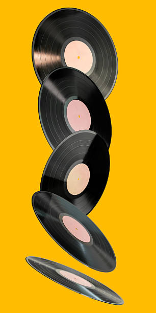 Stack of floating vinyl records on a yellow background. Concept of retro music, nostalgia, and classic audio formats. Perfect for vintage and music-themed designs