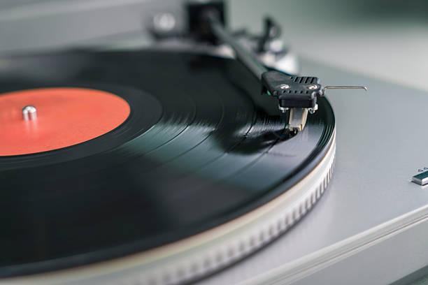 istock Close-up of turntable needle on spinning vinyl record 2257669374