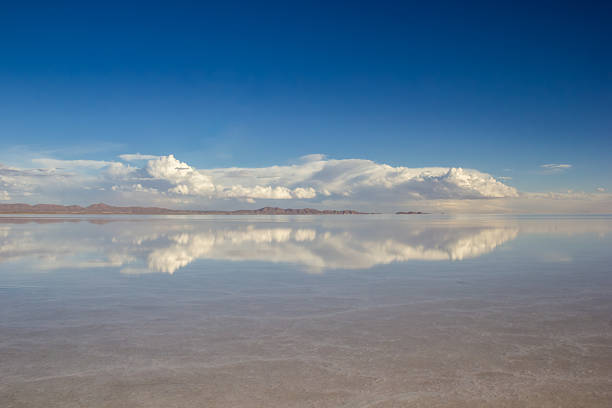 This panoramic landscape is an very high resolution multi-frame composite and is suitable for large scale printing. Afternoon view of Salar de Uyuni, Altiplano BoliviaSalar de Uyuni (or Salar de Tunupa) is the world's largest salt flat at 10,582 square kilometers (4,086 sq mi). It is located  in the Potosi and Oruro departments in southwest Bolivia, near the crest of the Andes, and is elevated 3,656 meters above the mean sea level.