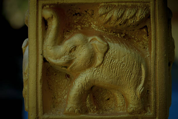Elephant relief carving on a temple structure, traditional Asian decorative art symbolizing strength, protection, and cultural heritage.