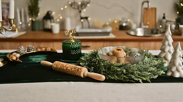 Festive kitchen table setting with Christmas decorations and baking tools