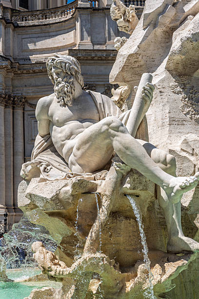 Italy - Rome - Piazza Navona - Muscular river god grasps ancient scroll while water tumbles over Bernini's dramatic sculpture
