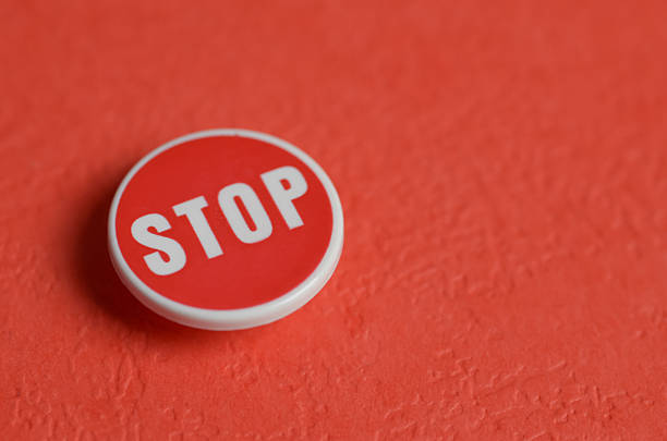 Red STOP pin on red background symbolizing warning and road safety alerts.
