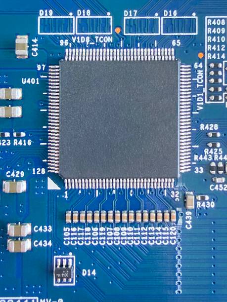 Macro closeup captures a detailed computer motherboard chip socket with gold pins, integrated circuits, and blue PCB traces in sharp focus against a dark tech background. Intricate electronic components including resistors, capacitors, and model numbers highlight advanced hardware engineering with vibrant blue hues and metallic accents. Full frame isolated view with copy space ideal for technology illustrations, circuit board concepts, or computing device visuals.​