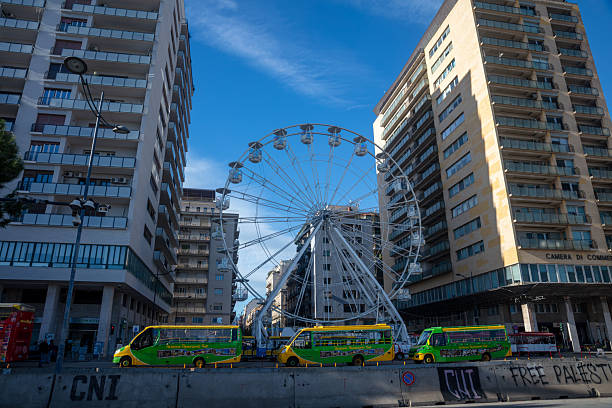 Palermo, Italy - December 25, 2025: City street view at Chrismas. Ferris wheel on the background.