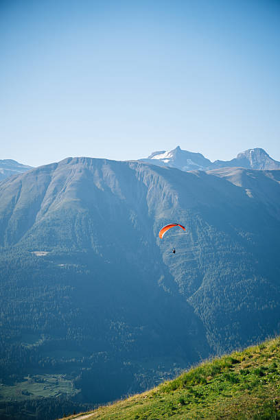 Paraglider soars over Jungfrau-Aletsch, Swiss Alps