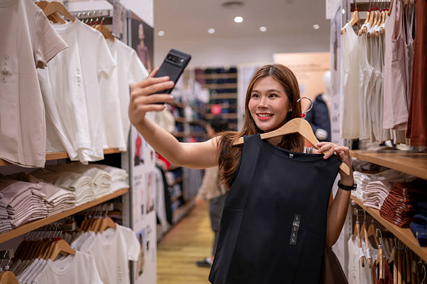 Young woman creating content for social media at a retail clothing store