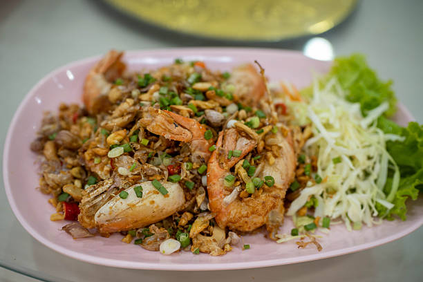 Succulent shrimp cooked with crisp vegetables and chili seasonings, showcasing the perfect harmony of heat, aroma, and freshness.