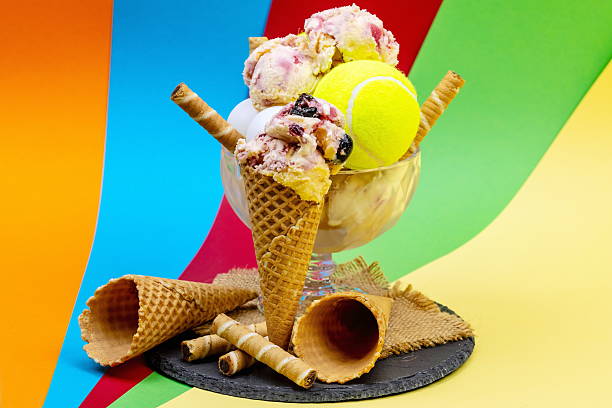 Ice cream cup as a trophy after a tennis match with ping pong balls on a colorful background