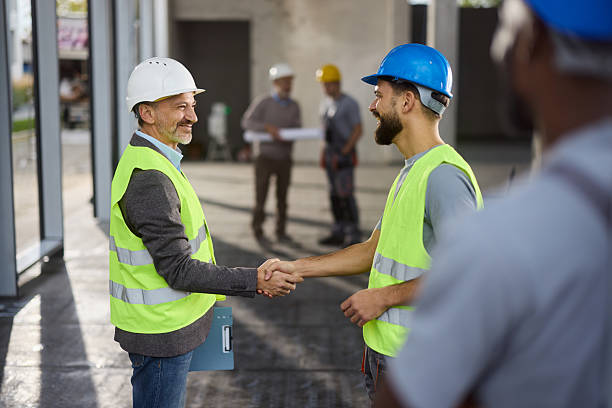 istock Happy male inspector shaking hands with his worker at construction site. 2257719923