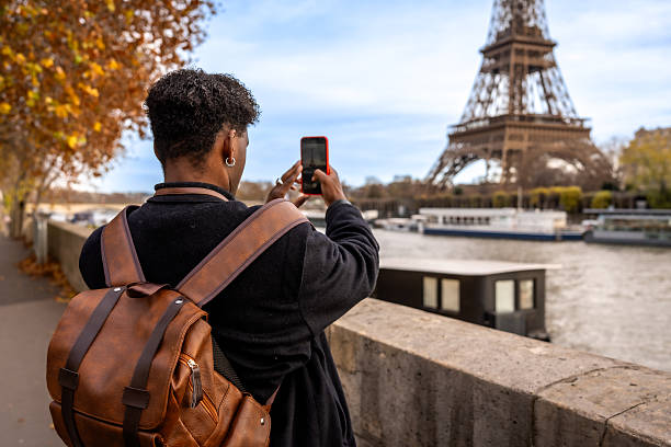 Handsome man talking on cellphone and enjoying in Paris.