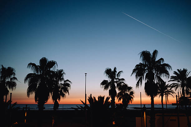 The sky transitions from a deep blue at the top to warm orange and yellow hues near the horizon, indicating the \