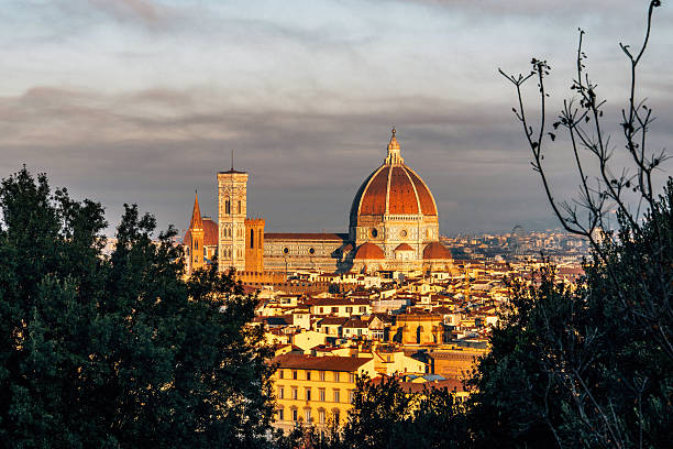Marvelous views of Florence Cathedral, with the sun rising over its medieval architecture. View from Caffè del Verone.