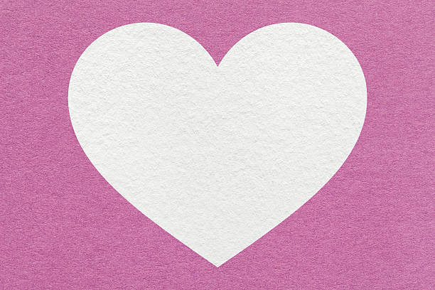 White heart on light lilac paper texture background with copy space for Valentines Day banner, template or greeting card.