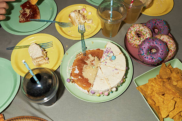 Teenager Hand Reaching for Cake Slice during Birthday Party Celebration