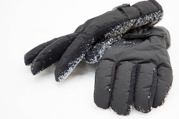 Pair of black gloves on a white background. Winter clothing.