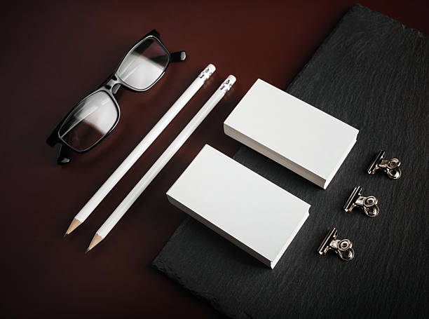 Blank business cards, pencils, glasses and binder clips.