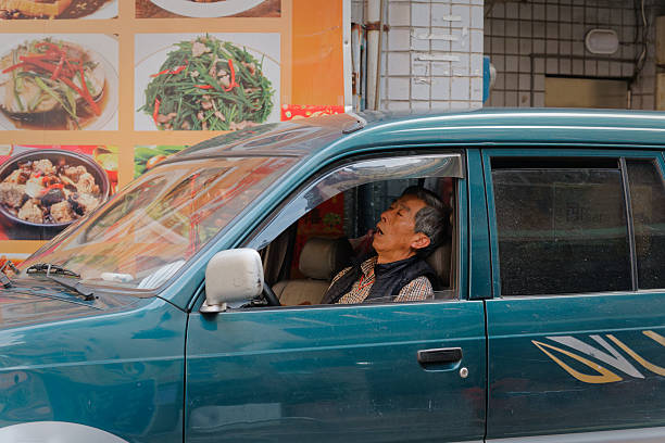 July 5,2014. Two scavengers in the street of the center of Beijing, China.They are sleeping in the street. They have no job.