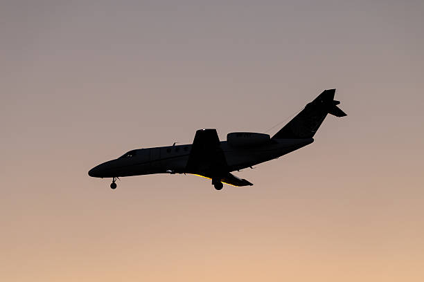 A Machjet International Cessna Citation CJ4, registration VH-PIY, landing at Sydney Kingsford Smith Airport from Launceston. This image was taken from Nigel Love Bridge, Mascot on a hot and sunny evening at sunset on 23 January 2026.