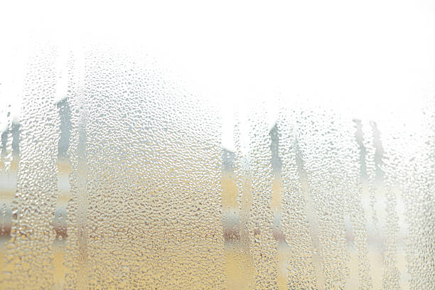 Wet window glass surface with heavy moisture and misted texture