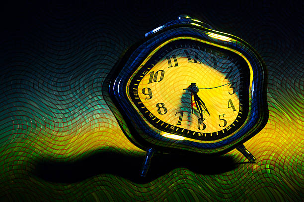 Surreal abstract image of a distorted clock with a glowing yellow face and warped numerals, set against flowing green and dark textured patterns. The bending shape and fluid grid overlay create a dreamlike, time-warping effect inspired by concepts of altered reality and psychological perception. This visually striking composition symbolizes the passage of time, impermanence, urgency, memory, and the subjective nature of reality.