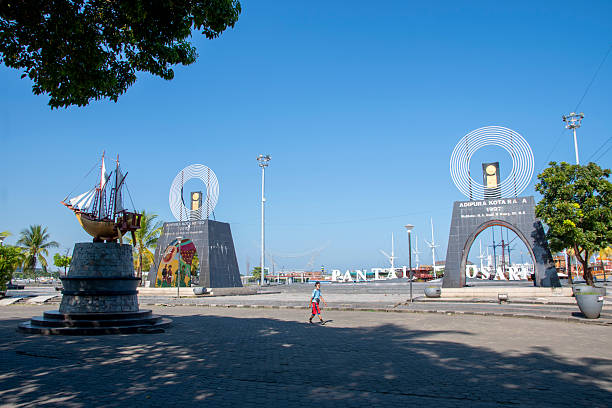 A visitor walks along Losari beach in Makassar city, South Sulawesi province, Indonesia. It's a  tourism icon and popular spot for locals to hang around.