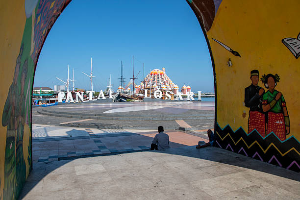 A visitor enjoys Losari beach in Makassar city, South Sulawesi province, Indonesia. It's a  tourism icon and popular spot for locals to hang around.