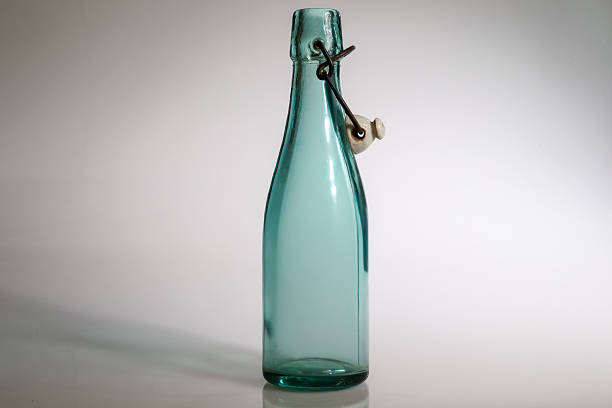 glass bottle with orangeade on white background